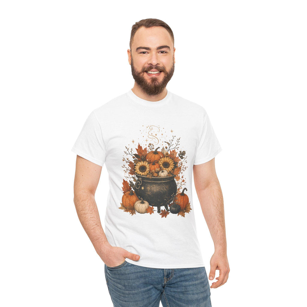A smiling man with a beard wears a white short-sleeved t-shirt with a fall-themed graphic of a black cauldron filled with sunflowers, pumpkins, and autumn leaves.